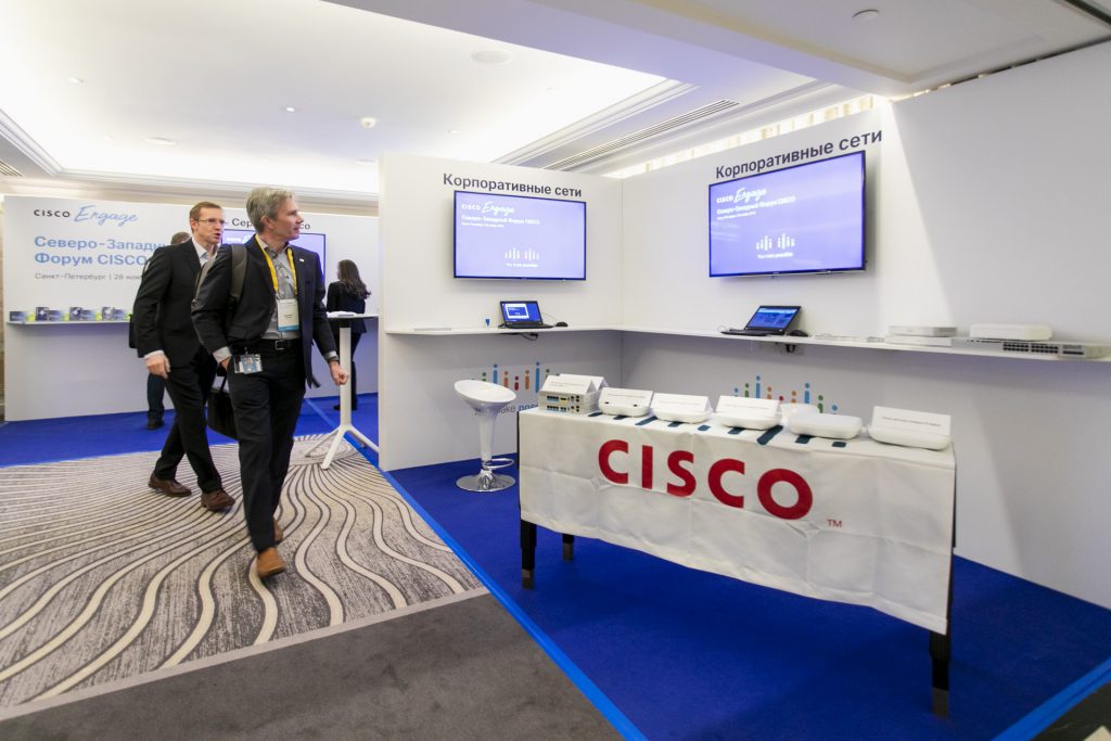 Guests speaking in a branded event space
